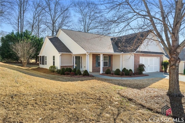 view of front of property with an attached garage, brick siding, concrete driveway, roof with shingles, and a front yard