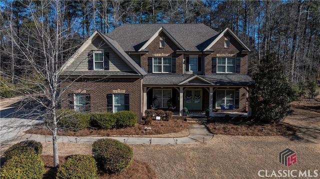 craftsman house with brick siding and a porch