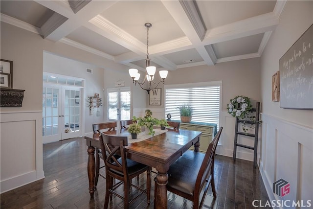 dining room featuring dark wood finished floors, beamed ceiling, and french doors