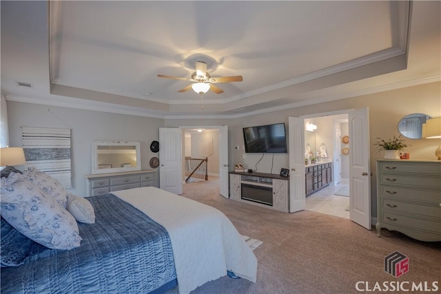 bedroom featuring ornamental molding, a raised ceiling, a ceiling fan, and light colored carpet