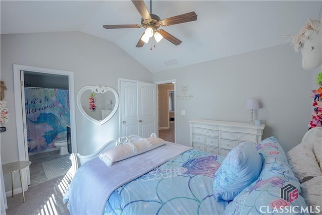 bedroom with lofted ceiling, carpet, connected bathroom, and a ceiling fan