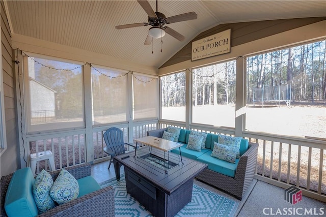 sunroom / solarium featuring lofted ceiling and ceiling fan