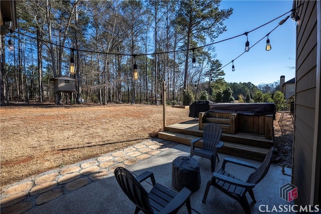 view of patio / terrace with a hot tub