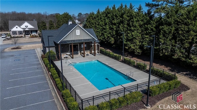 pool featuring a patio area and fence