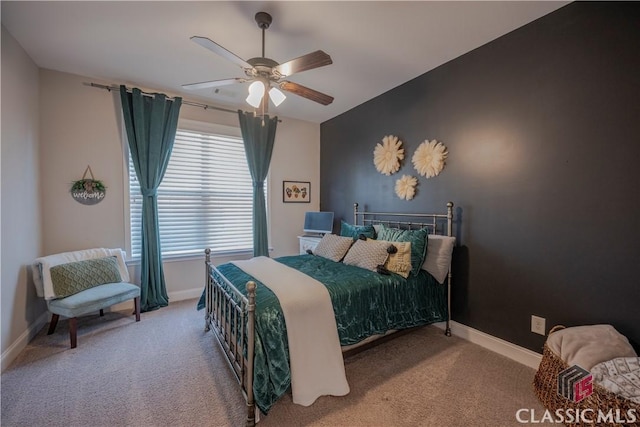 carpeted bedroom with ceiling fan and baseboards