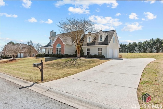 view of front of home with a garage, concrete driveway, and a front lawn