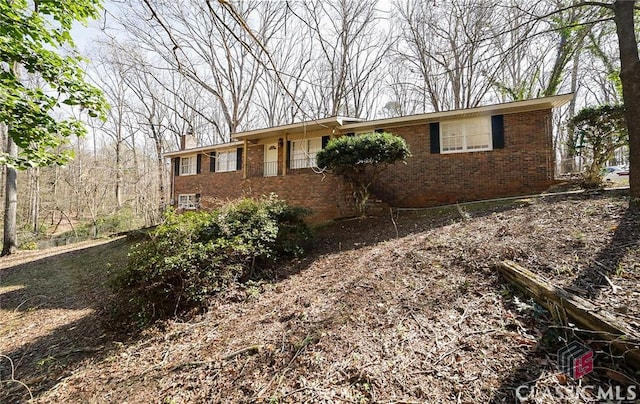 single story home featuring brick siding