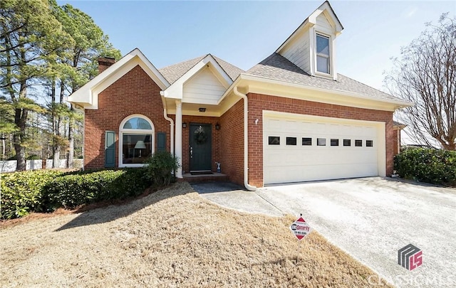 view of front of property with concrete driveway, brick siding, an attached garage, and roof with shingles