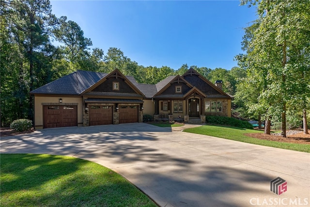 craftsman-style house featuring a front lawn, driveway, and an attached garage