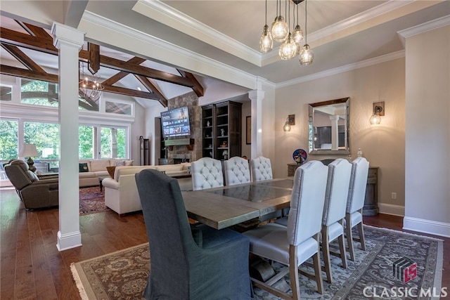 dining area with lofted ceiling with beams, a notable chandelier, wood finished floors, baseboards, and decorative columns