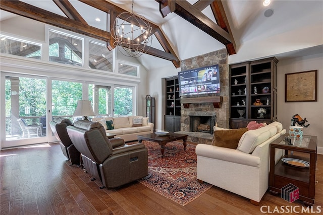 living room featuring high vaulted ceiling, a stone fireplace, dark wood-style flooring, and an inviting chandelier