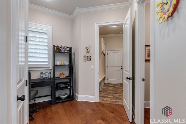 interior space with crown molding, baseboards, and wood finished floors