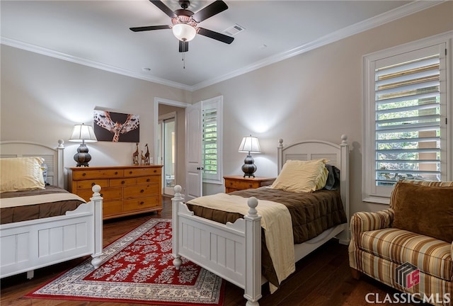 bedroom with multiple windows, wood finished floors, visible vents, and crown molding