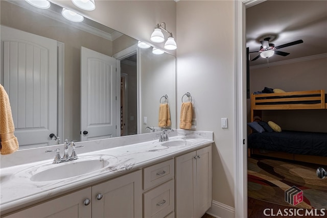 full bath featuring a sink, double vanity, and crown molding