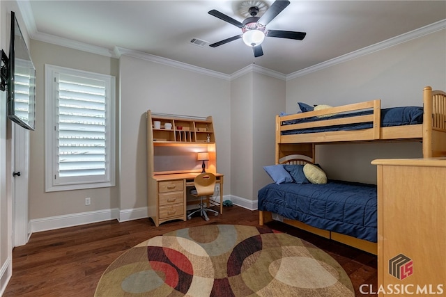 bedroom with ornamental molding, visible vents, baseboards, and wood finished floors