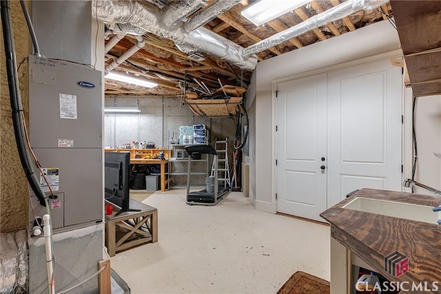 unfinished basement featuring heating unit