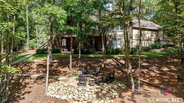 exterior space featuring an outdoor fire pit and a patio area