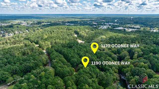 birds eye view of property featuring a view of trees