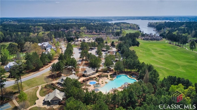 birds eye view of property with a water view and a view of trees