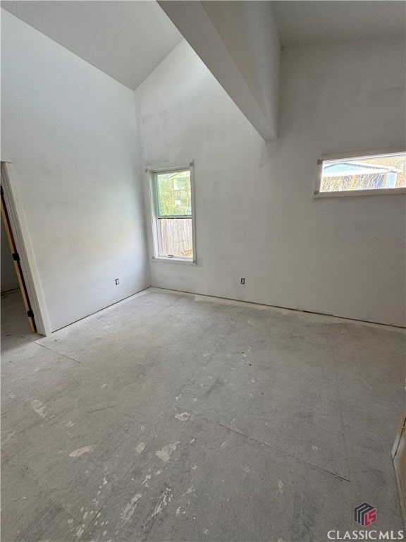 unfurnished room featuring high vaulted ceiling