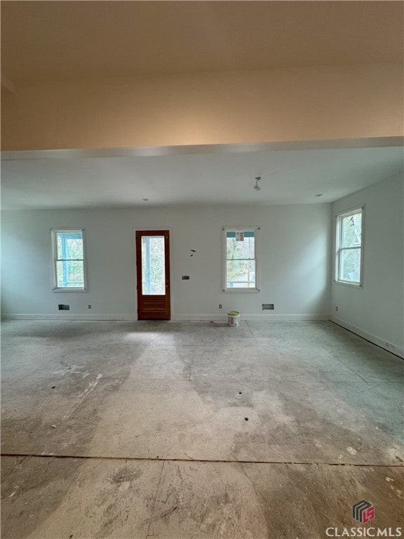 interior space featuring a healthy amount of sunlight and baseboards