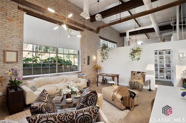 interior space with baseboards, brick wall, and finished concrete floors