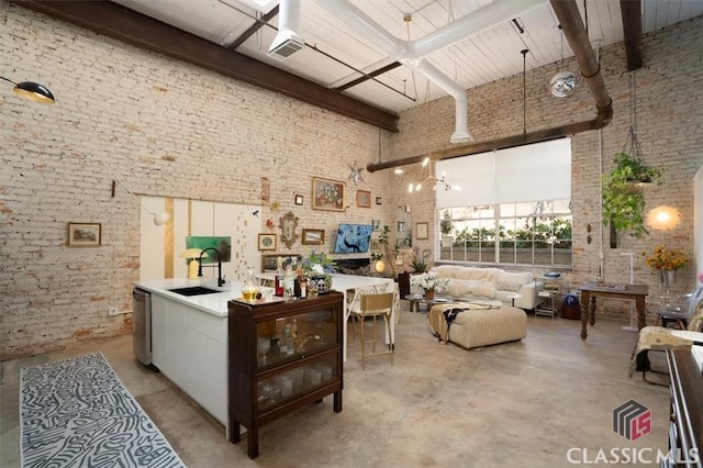 dining room with concrete flooring, a high ceiling, and beam ceiling