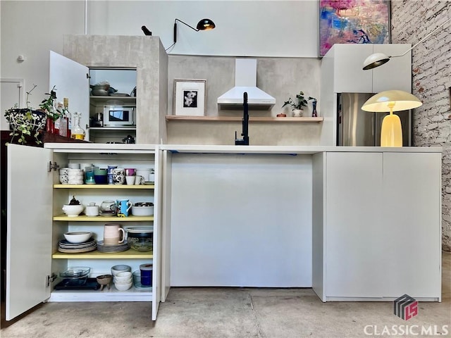 home office featuring concrete floors and a towering ceiling