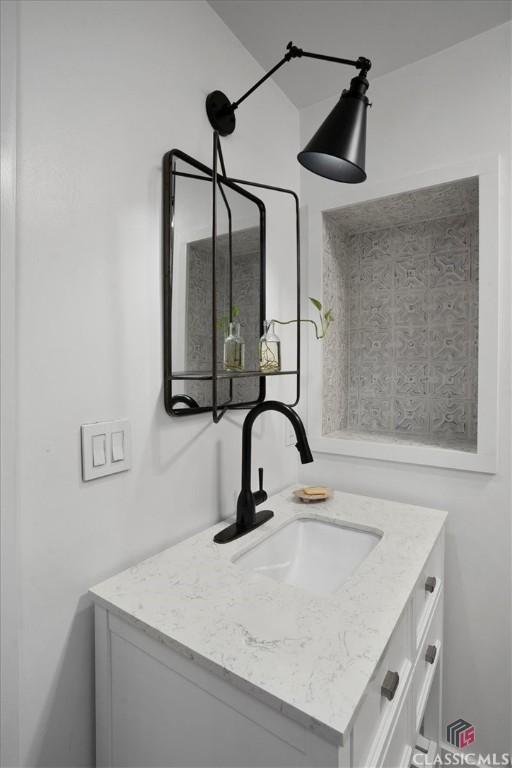 bathroom with vanity, a shower stall, and toilet