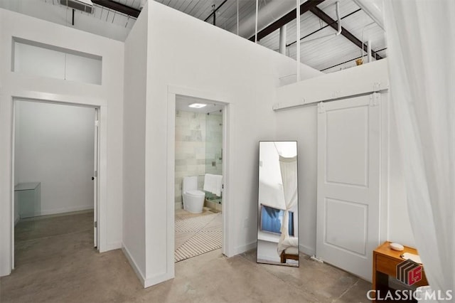 full bath featuring toilet, a stall shower, and a sink