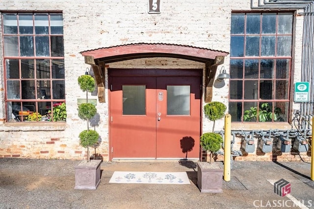 foyer entrance featuring concrete flooring and a high ceiling