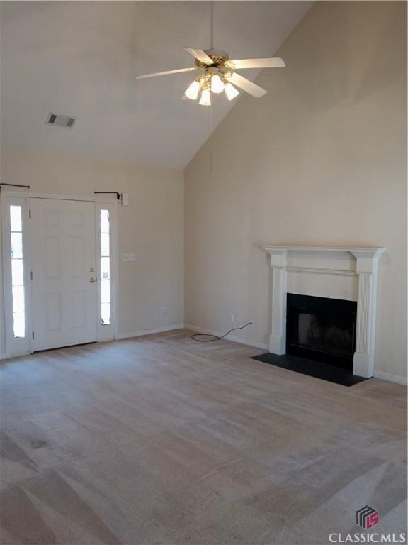 unfurnished living room featuring a fireplace with flush hearth, carpet, visible vents, and high vaulted ceiling