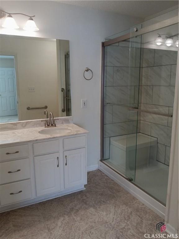 full bathroom with a shower stall and vanity