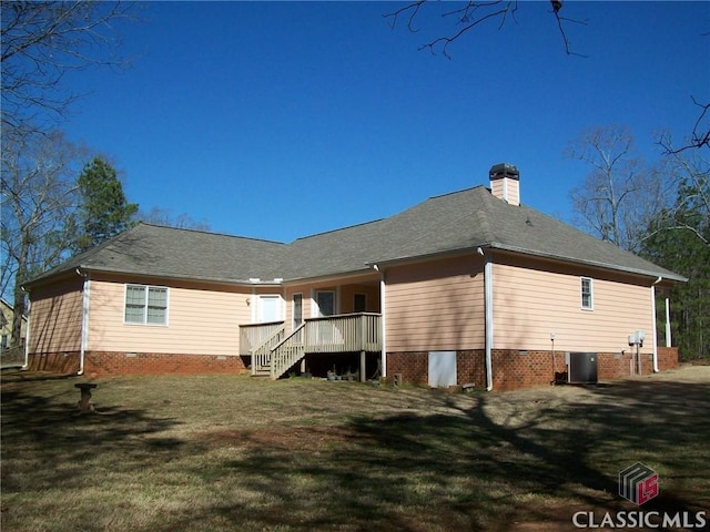 back of house featuring cooling unit, crawl space, a yard, and a chimney