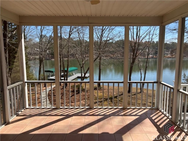 unfurnished sunroom with a water view and wood ceiling