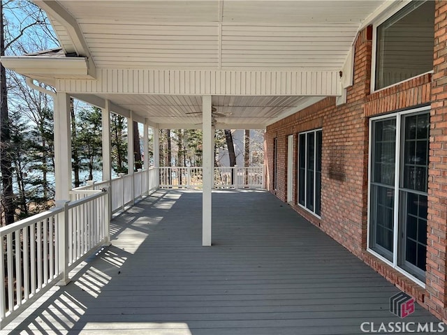 wooden terrace featuring ceiling fan