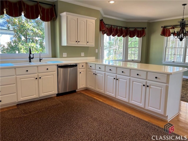 kitchen featuring a sink, light wood-style floors, ornamental molding, and dishwasher