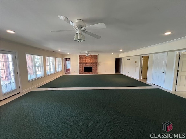 unfurnished living room with ceiling fan, a fireplace, carpet flooring, and recessed lighting