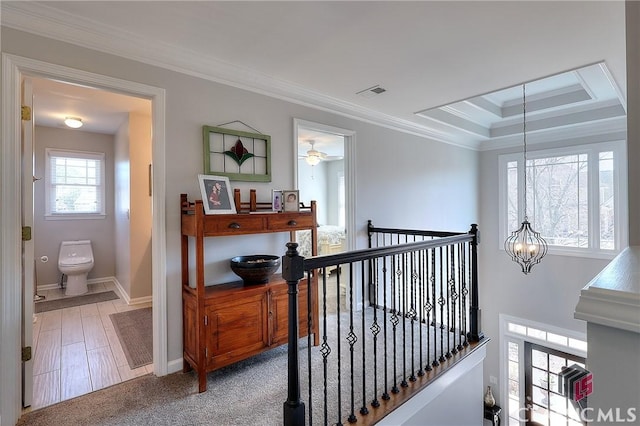 hall with crown molding, visible vents, an inviting chandelier, an upstairs landing, and baseboards