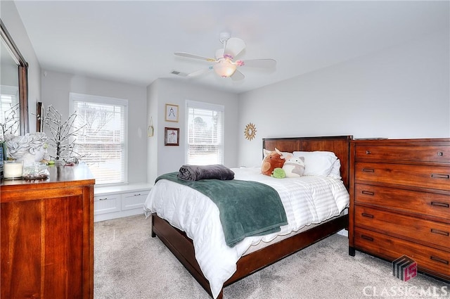 bedroom featuring light carpet, ceiling fan, and visible vents