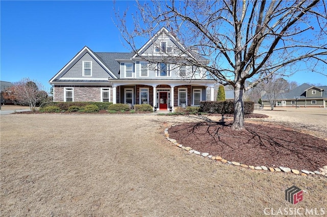 view of front of home featuring stone siding and covered porch