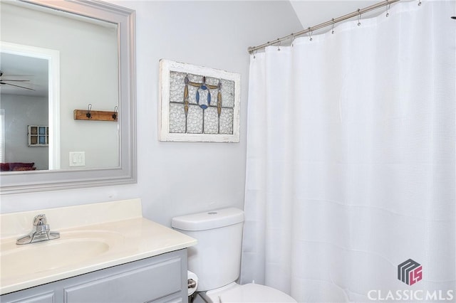 full bathroom with toilet, a ceiling fan, and vanity