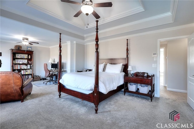 carpeted bedroom featuring ceiling fan, a raised ceiling, and crown molding