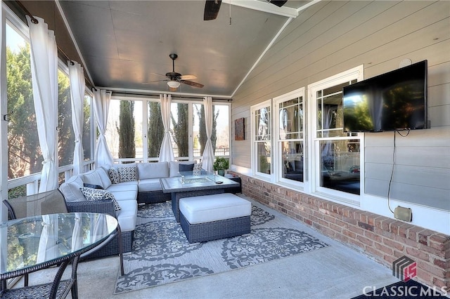 sunroom / solarium featuring vaulted ceiling and a ceiling fan