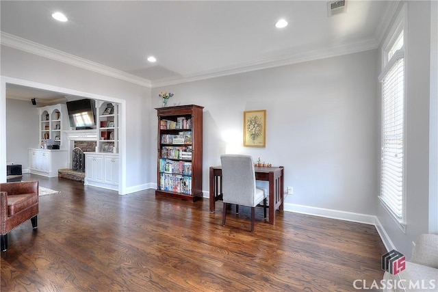 office space with a fireplace, visible vents, wood finished floors, and ornamental molding