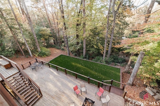 wooden terrace with a lawn