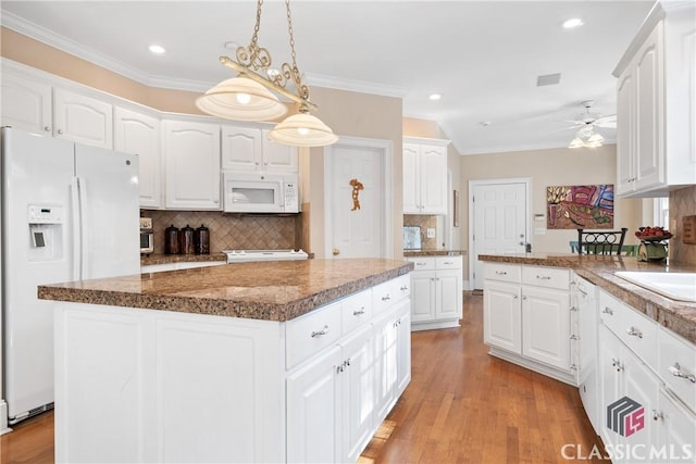 kitchen with crown molding, ceiling fan, white appliances, white cabinetry, and decorative backsplash