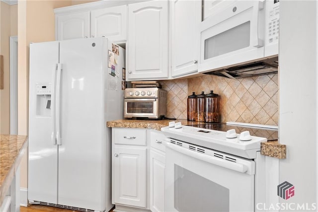 kitchen with backsplash, white cabinets, white appliances, and a toaster