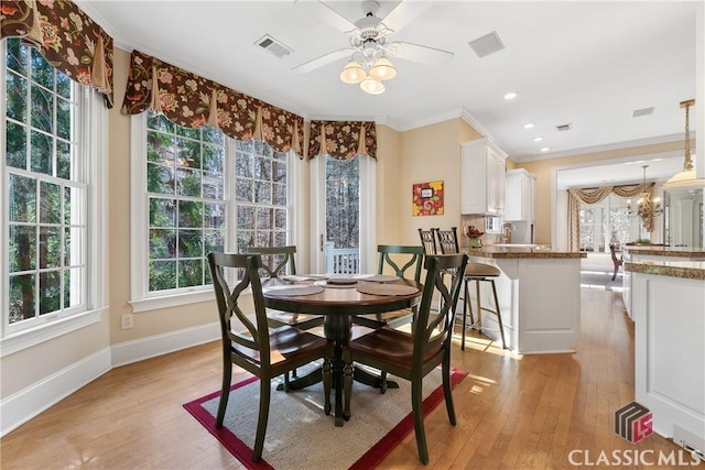 dining room featuring visible vents, a healthy amount of sunlight, and light wood-type flooring