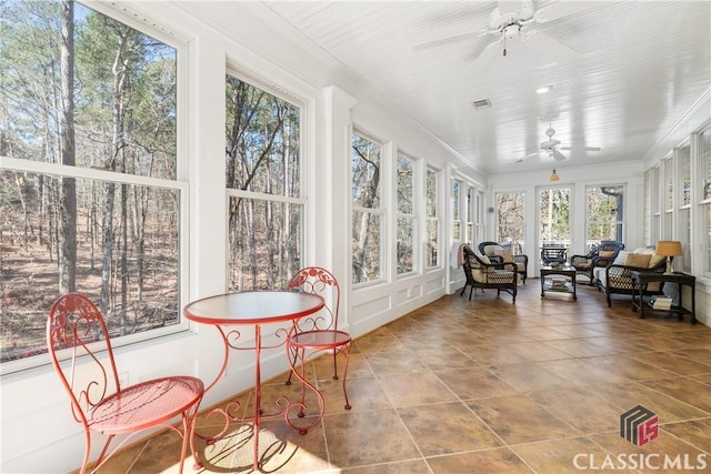 sunroom / solarium featuring visible vents, ornamental molding, and tile patterned floors